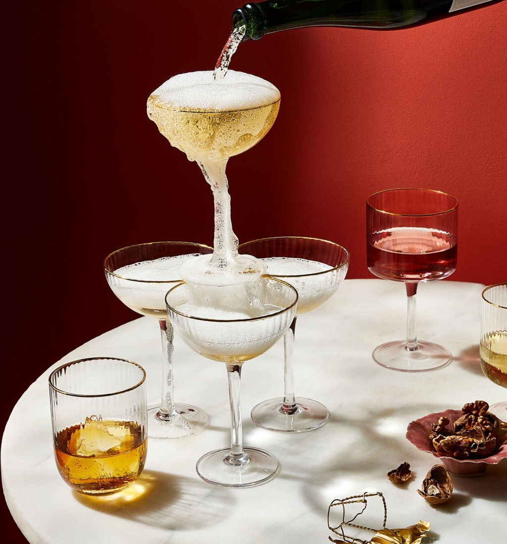 champagne tower made of the best coupe champagne glasses with vintage gold rims