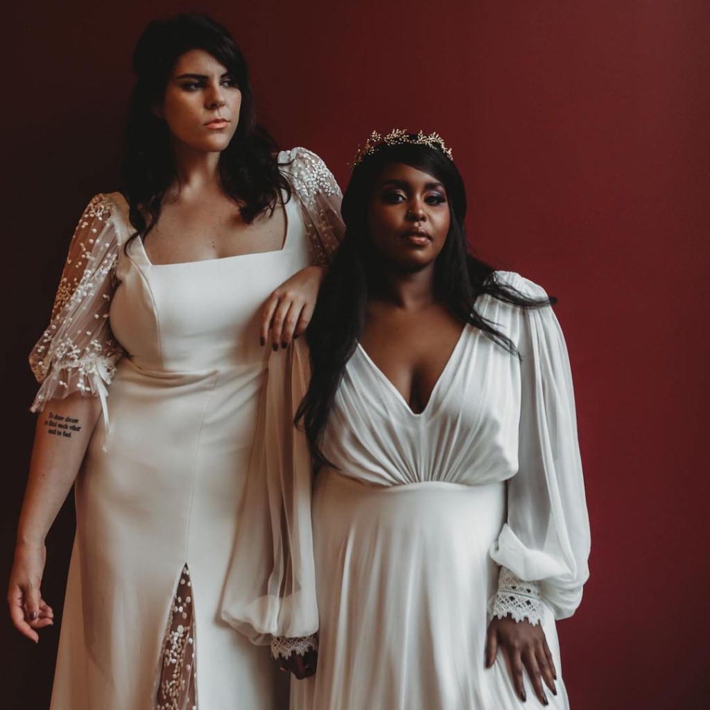 two brides wearing long sleeve plus size bridal gowns