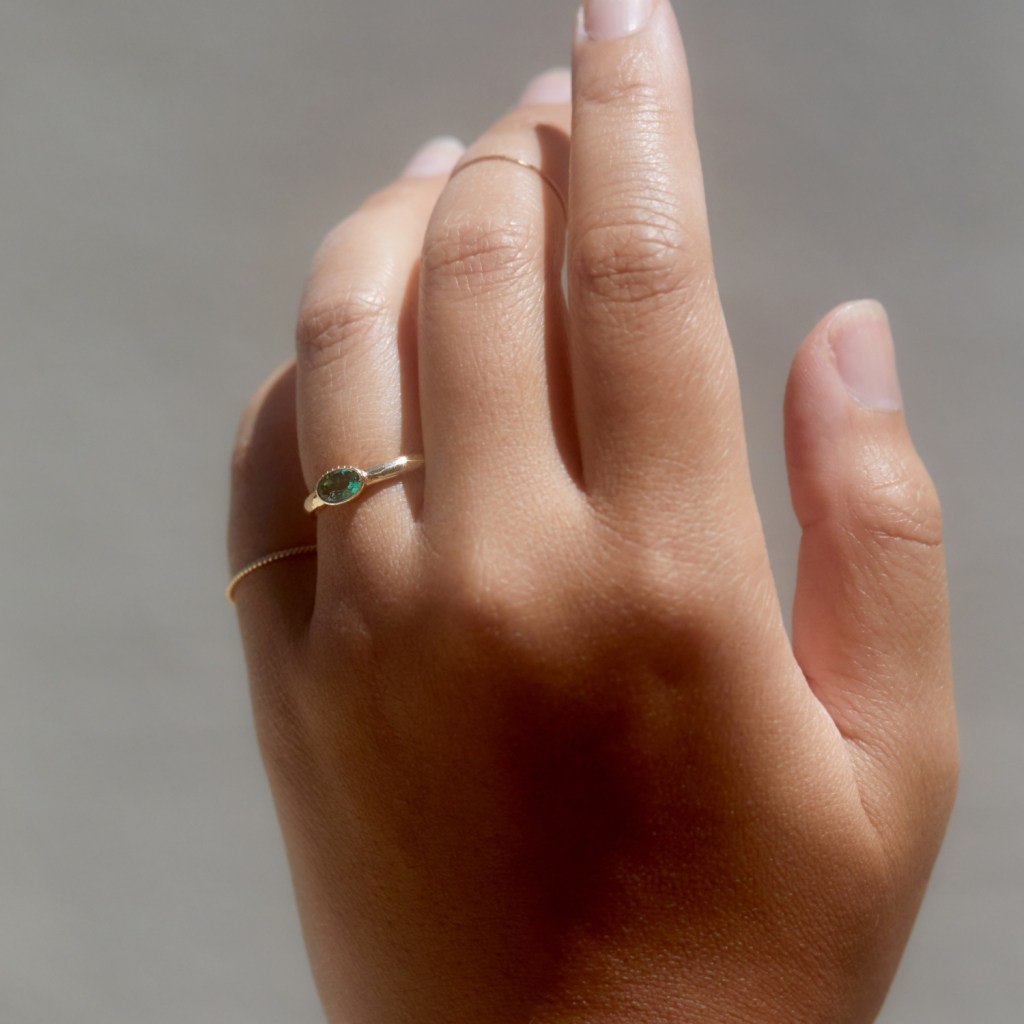 solitaire green stone yellow gold bezel band 